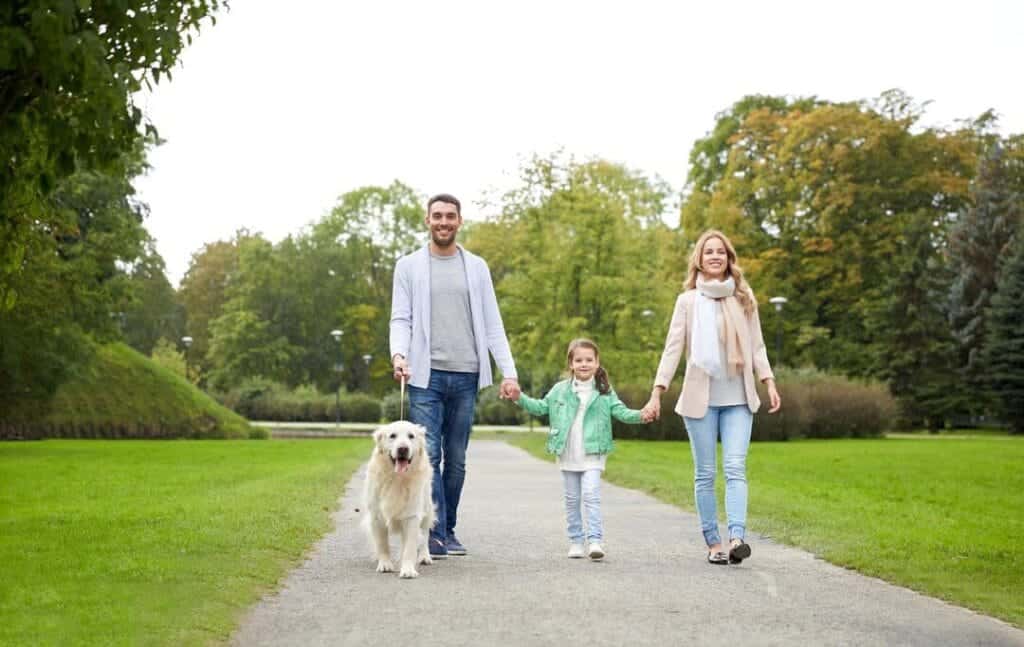 family walking outdoors to enjoy the physical and mental health benefits of walking